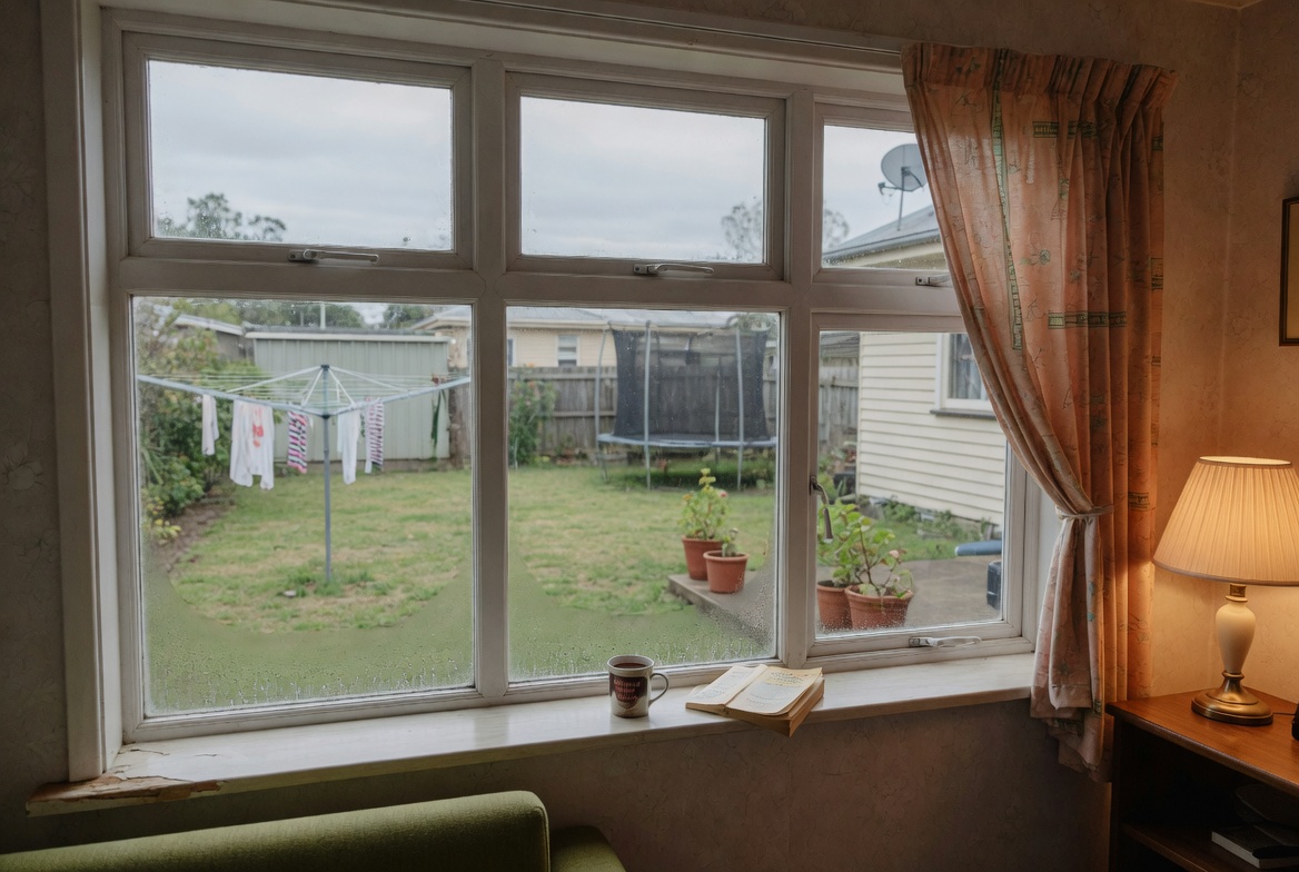 Old worn timber sash window with peeling paint on Auckland villa