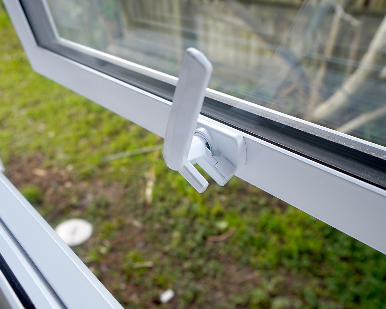 Close-up of window latch and hardware on replacement window